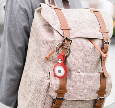 Bluetooth locator tracker leather case attached to backpack.