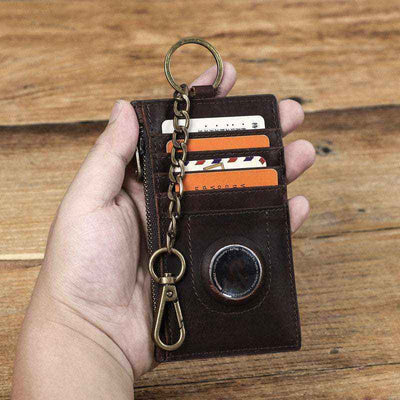 Brown leather zippered card holder with keychain, suitable for holding multiple cards.